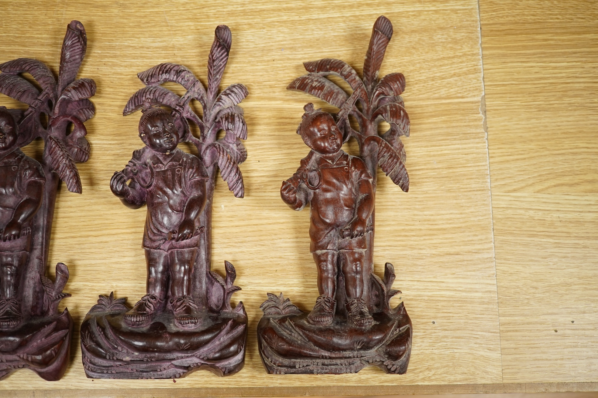 Four 1960's Chinese Cultural Revolution figures of boys holding a rifle, 33cm high